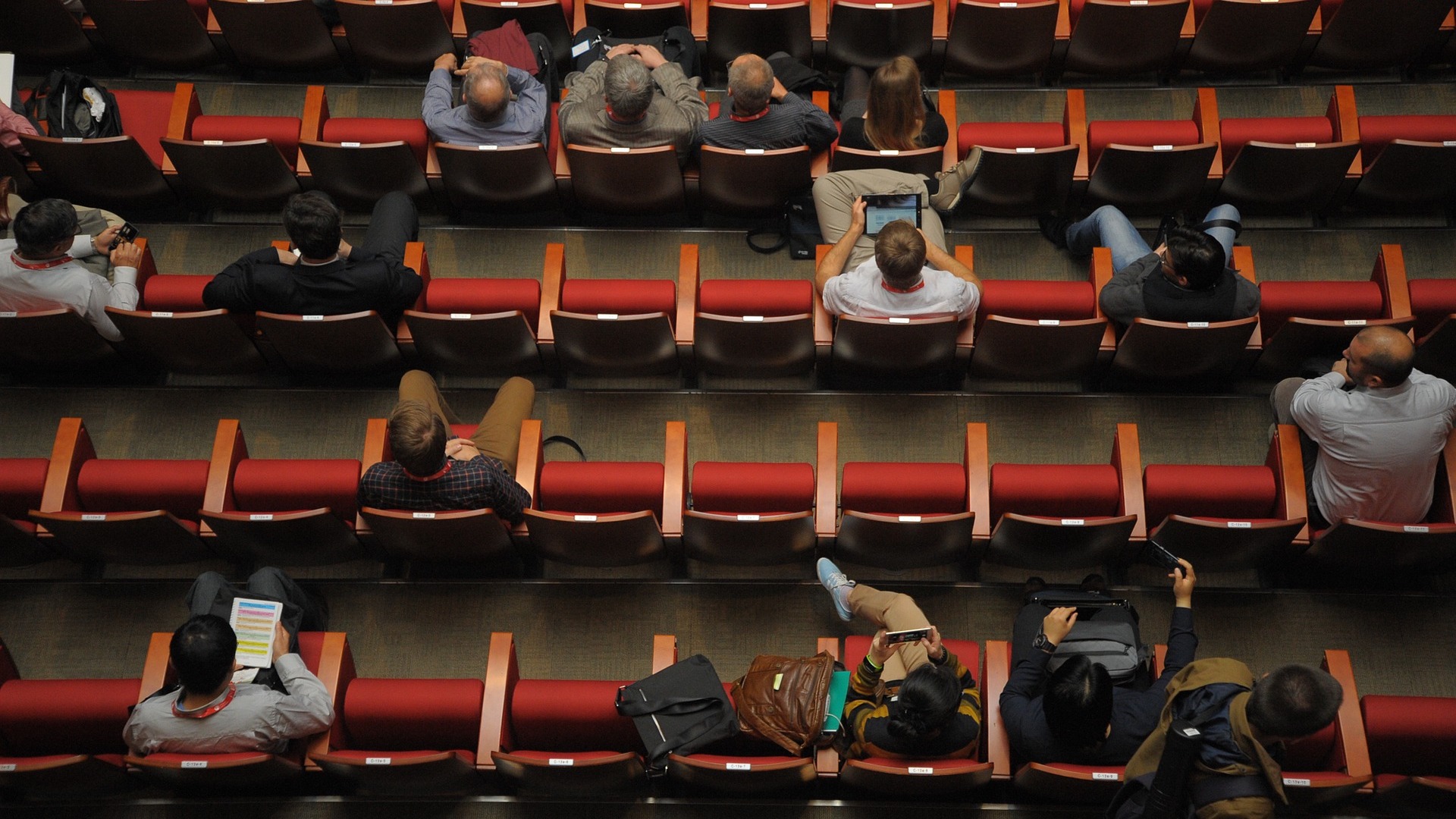 Top-down photo of an audience sitting in rows in a theatre